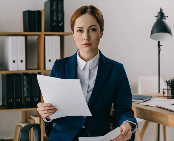 portrait-of-female-lawyer-in-suit-with-documents-i-AGD8X3M-p7qwg02rb0v0sxuf4i840m2c6gm4mxv5fsg4x9flk
